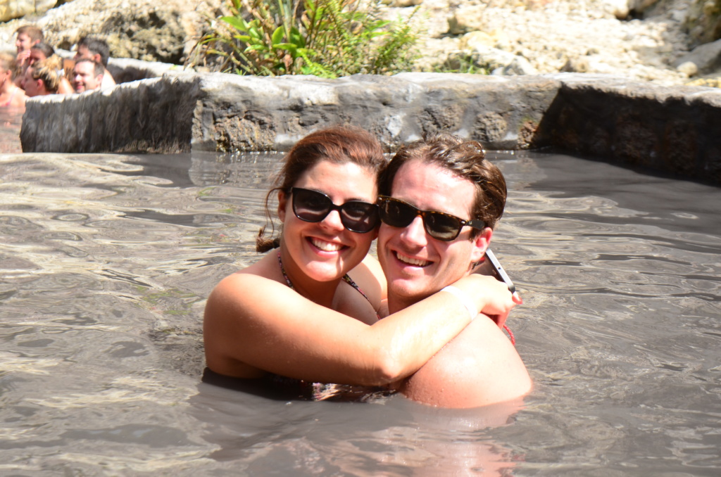 Couple smiling at relaxing in a mud bath at the Sulphur Springs St Lucia