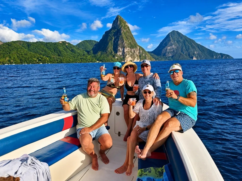 Guests on board a Real Deal Boat Tours boat with the Pitons behind them
