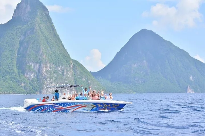 The Real Deal Boat Tours speedboat on the water in front of the Pitons, Saint Lucia