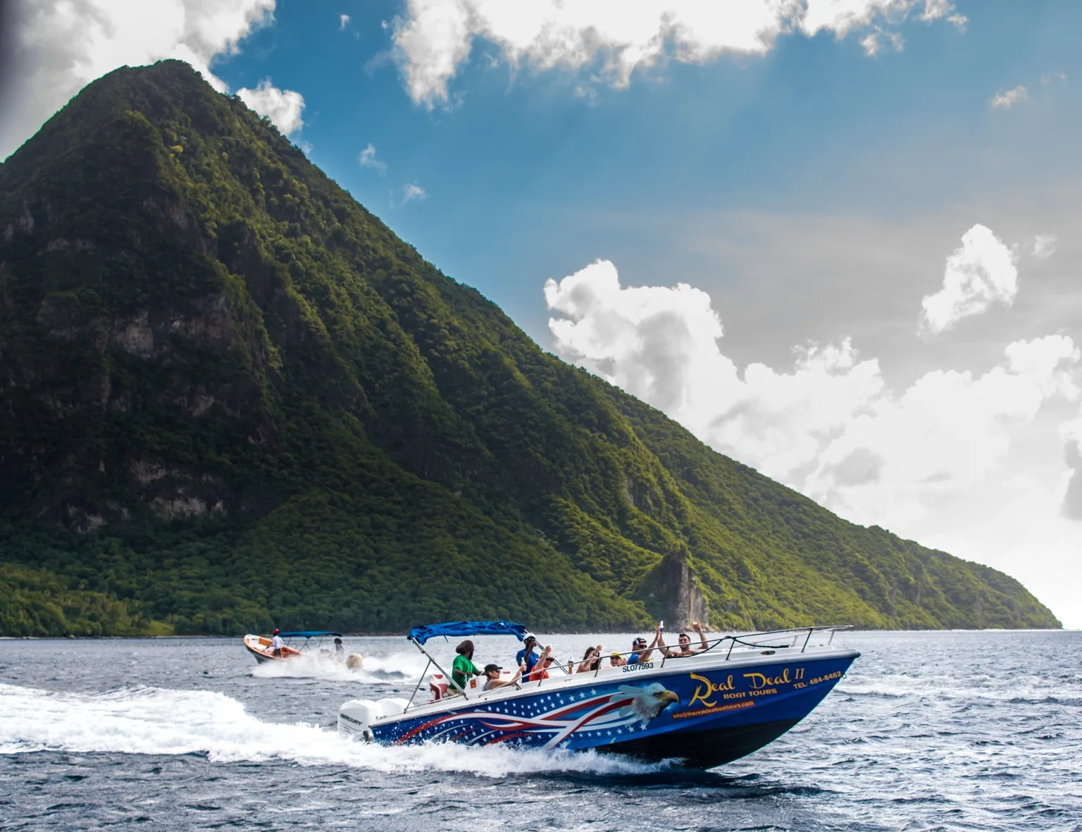The Real Deal Boat Tours speedboat cruising beneath the Pitons, St. Lucia