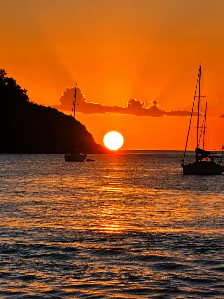 Sunset over Reduit Beach with sailboats at anchor, St. Lucia